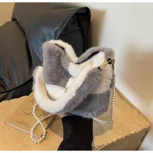 Detail of grey and white checkered faux fur bucket bag with pearl chain strap