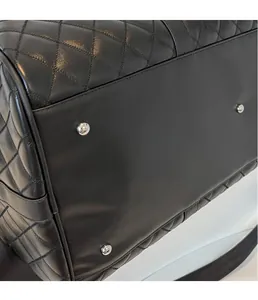Close-up of diamond quilted leather bag side with protective silver hardware studs