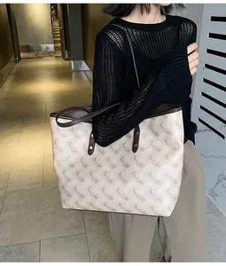 Large capacity tote bag with horse carriage pattern shown on model for daily commuting