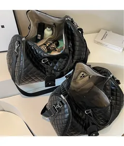 Detail of black quilted travel bag showing spacious interior with multiple storage pockets