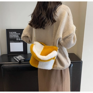 Detail of yellow and white checkered plush bag with elegant pearl chain strap