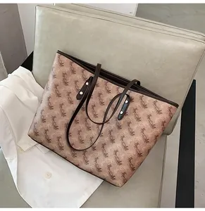Top-down view of a vintage tote bag with horse carriage pattern and leather trim details