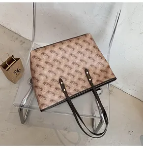 Detailed shot of a large tote bag with horse carriage print on a designer chair