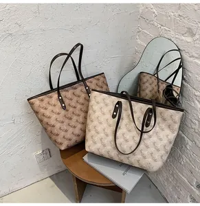 Detail view of large tote bags with carriage print in dark brown and creamy white