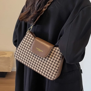 Classic houndstooth underarm bag with brown leather flap and stylish shoulder strap