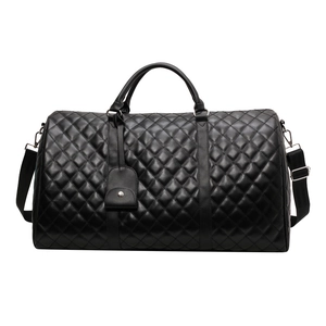 Black quilted leather large travel bag with dual handles and adjustable shoulder strap
