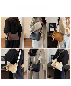 Detail view of stylish small square crossbody bags in four colors with bunny charms