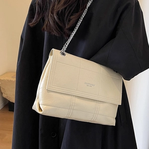Quilted beige shoulder bag with silver chain strap and polished faux leather finish