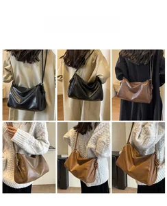 Detail view of large Boston bag showing soft PU leather texture and knotted side accents