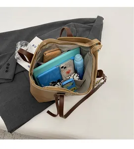 Detailed interior view of a large khaki tote bag showing spacious storage for daily items