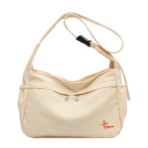 Minimalist beige canvas crossbody bag with dual zipper pockets and adjustable black strap