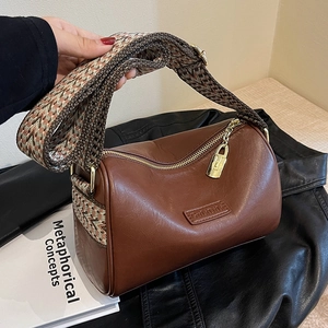 Brown barrel Boston bag with vintage wide woven strap and golden padlock detail