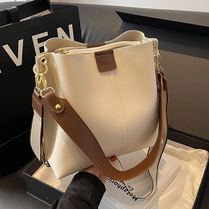 Fashionable beige bucket bag with brown wide strap and gold hardware for women