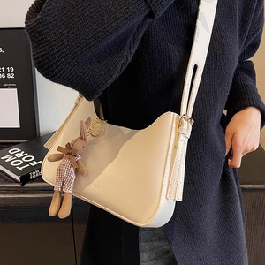 Minimalist beige crossbody bag with fashion engraving and cute rabbit plush charm