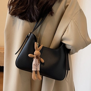 Classic black PU leather hobo bag for women featuring a cute bunny plush charm accessory