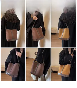 Model showcasing a large capacity retro suede bucket bag with stylish shoulder strap
