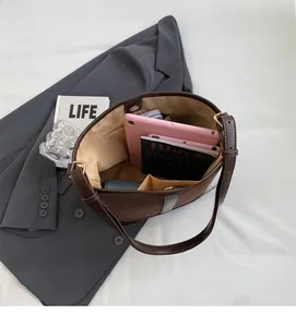 Interior view of brown tote bag showing large capacity for tablet and pockets