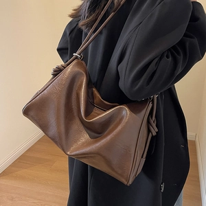 Deep brown faux leather crossbody bag with knot shoulder strap and large capacity
