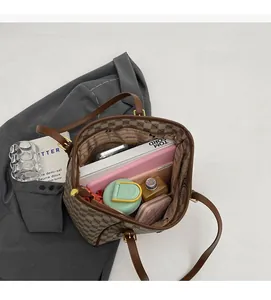 Top view of spacious brown tote interior with tablets and various items inside