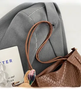 Detail of woven texture on brown large capacity tote bag with dual top handles