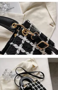 Dettaglio della fibbia in metallo dorato e tessuto tweed bianco e nero sulla borsa