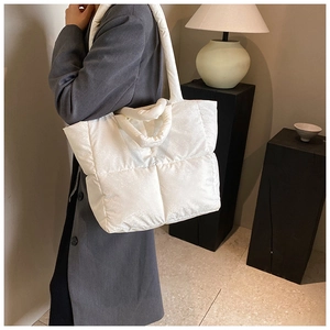 Dettaglio della borsa tote trapuntata bianca con tracolla imbottita e lucida
