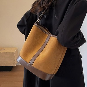 Caramel suede bucket bag with leather trim and adjustable strap for women in autumn