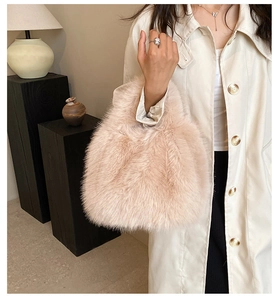 Close-up of soft beige faux fur handbag with stylish textured finish and plush feel