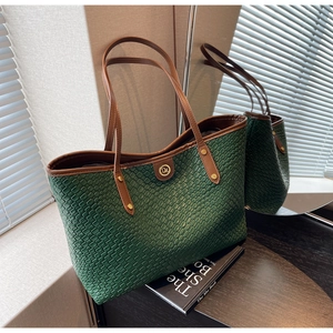 Détail du grand sac cabas vert foncé avec lanières en cuir marron et boucle dorée chic