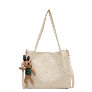 Cream woven large tote bag with cute bunny pendant and shoulder strap on white background