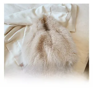 Detailed close-up of soft fluffy beige faux fur handbag showing plush texture and handle