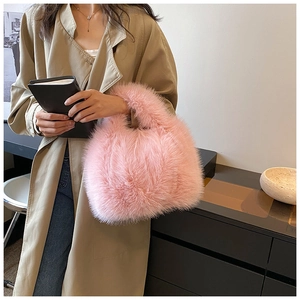 Detail of pink faux fur handbag showing long fluffy texture and soft handle design