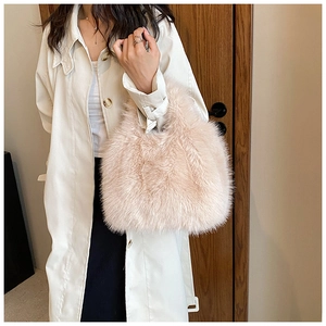 Close-up of fluffy faux fur handbag in beige, styled with a white trench coat