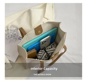 Macro view of beige tote bag interior showing large capacity for tablet and phone