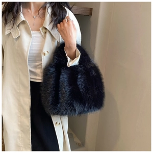 Detailed view of plush black faux fur texture on a minimalist winter tote handbag