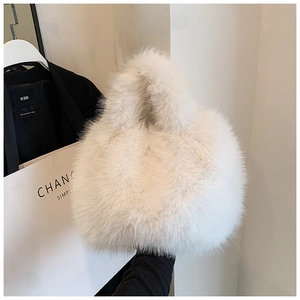Close-up of white faux fur handbag texture with soft plush material and top handle