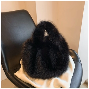 Close-up of soft black faux fur texture on a luxury plush winter tote handbag