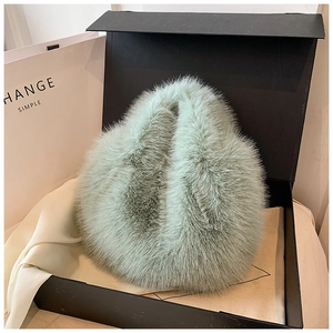 Detailed view of fluffy light green faux fur accessory in premium gift box packaging