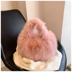 Close-up of soft pink faux fur texture and seamless handle on a plush handbag