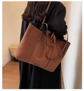 Detail of vintage brown suede tote bag showing rich texture and large capacity for daily use