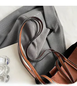 Close-up of slim double shoulder straps on a brown faux suede tote bag for women