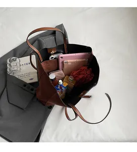 Detailed view of the brown tote bag interior showing ample space for iPad and essentials