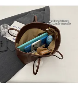 Detailed interior of large brown leather tote bag showing spacious compartments and storage