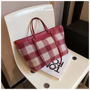 Close-up of red and beige checkered wool tote bag with premium leather handles