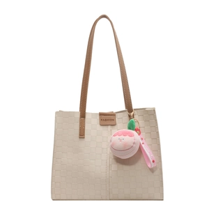 Large beige tote bag with checkered texture and pink peach plush charm for daily commute