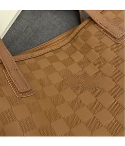 Detail shot of brown checkered pattern fabric on a spacious luxury tote bag