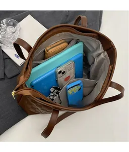 Detail view of large checkered tote interior with tablet, books, and phone storage