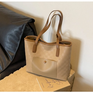 Detail of khaki checkerboard embossed tote bag with front pocket and snap button
