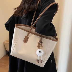 Large beige PU leather tote bag with brown handles and a cute plush charm for daily use