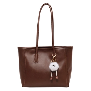 Large dark brown tote bag with white plush monster keychain for daily commuting